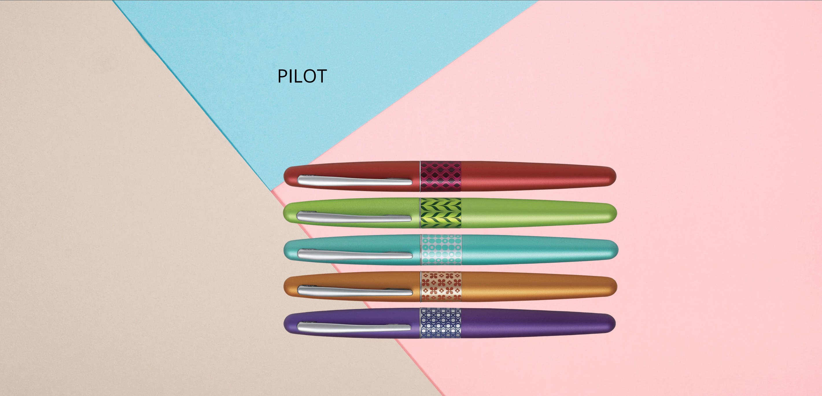 Row of five Pilot Metropolitan fountain pens in different colours with decorative bands on a pastel background