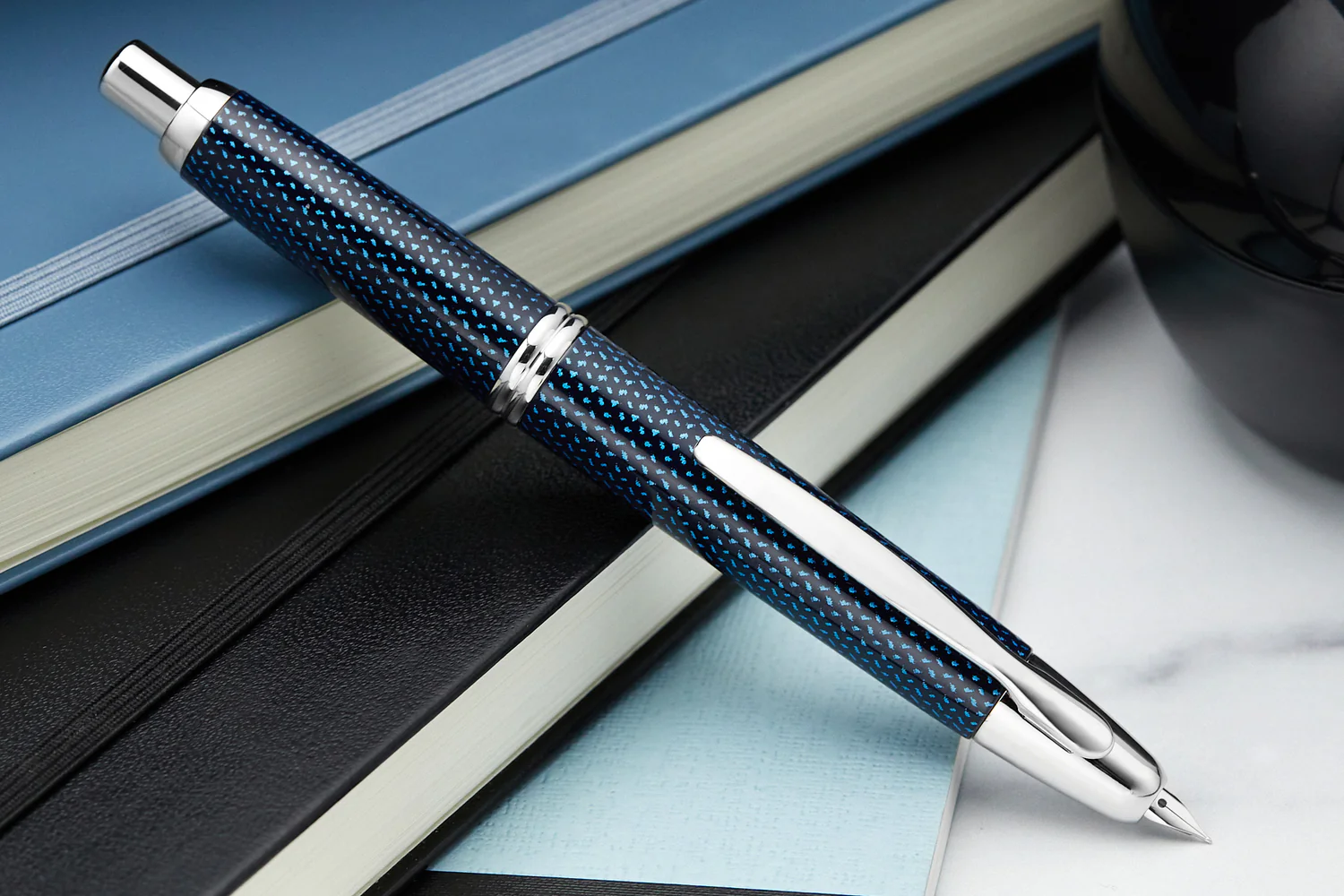 Pilot Vanishing Point fountain pen with retractable nib design on notebooks, highlighting pen care and maintenance